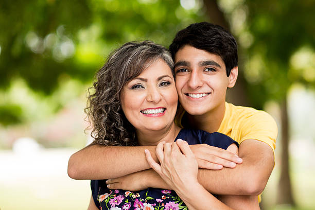 Teen and parent hugging